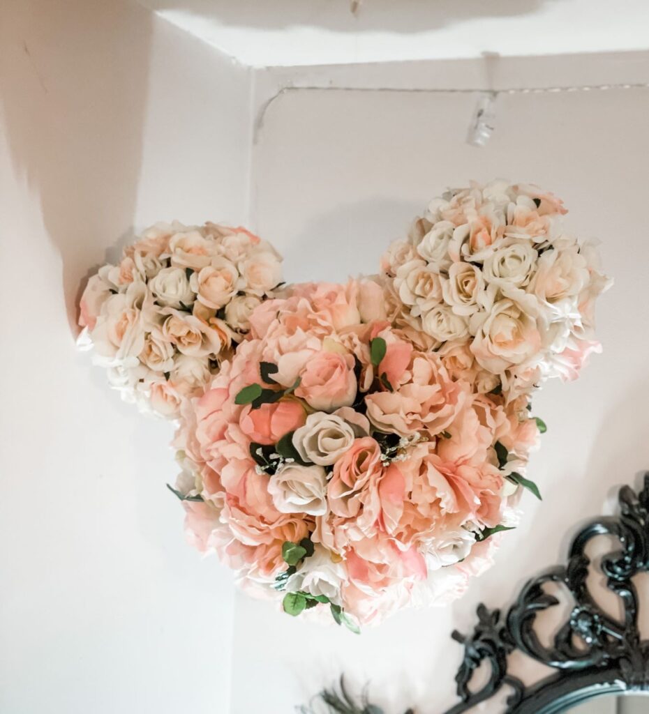 Silk flowers decorate 3 spheres to make a Mickey head